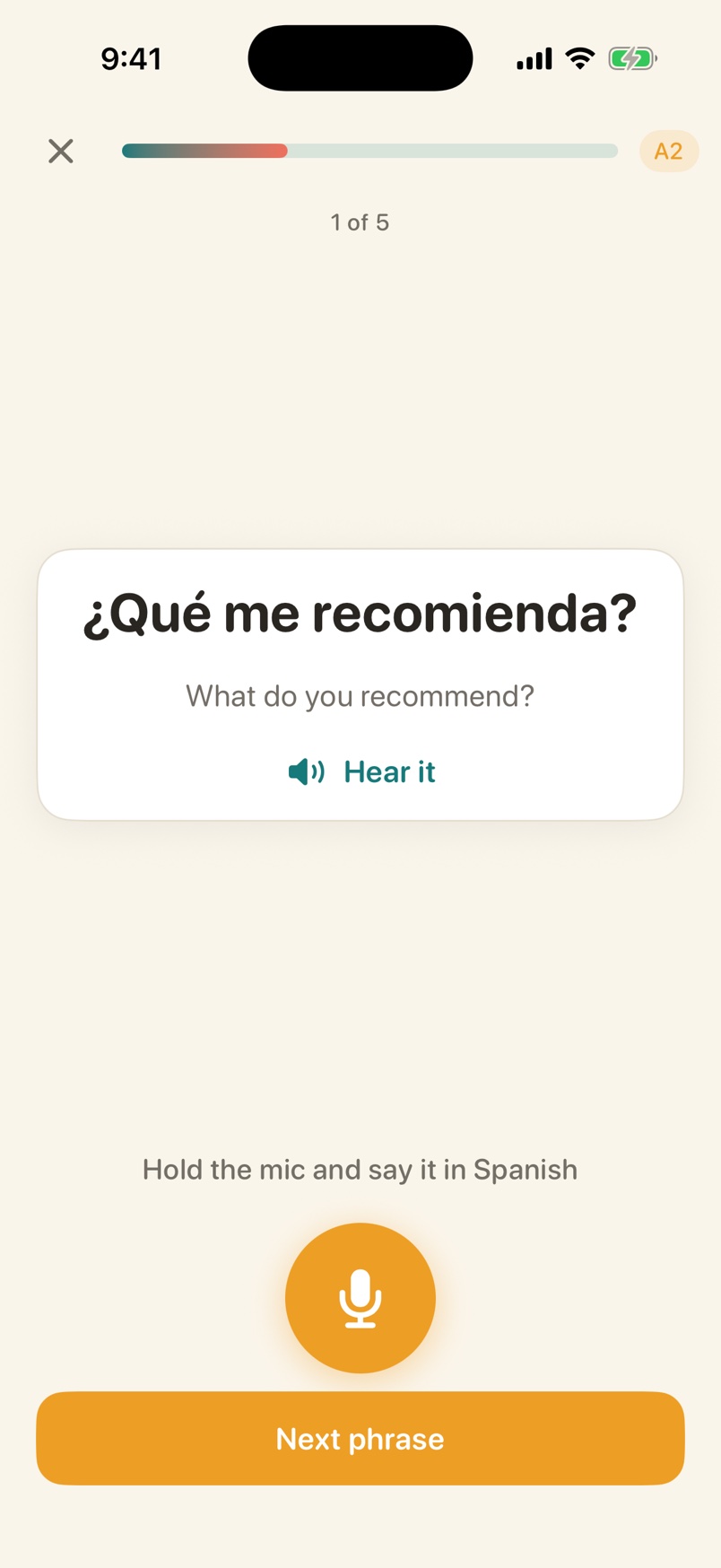Voxolo vocabulary stage showing the phrase ¿Qué me recomienda?, its English translation, a Hear it button, and a microphone with the prompt Hold the mic and say it in Spanish